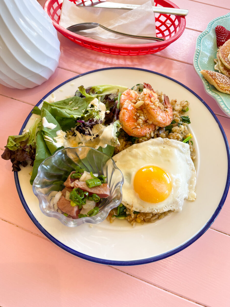 The plate that consists of fried rice, 1 fried egg, 3pcs garlic shrimps, Ahi Tataki ginger shoyu poke & Caesar salad.