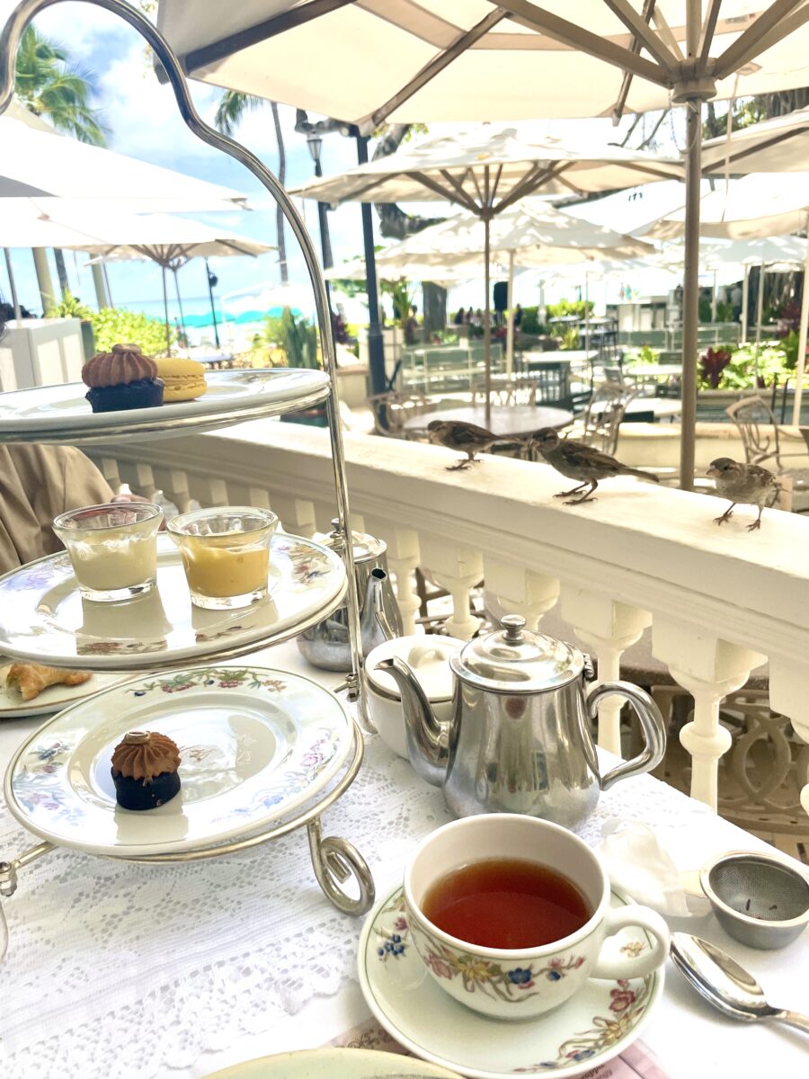 Three sparrows around the three-tiered stand for afternoon tea